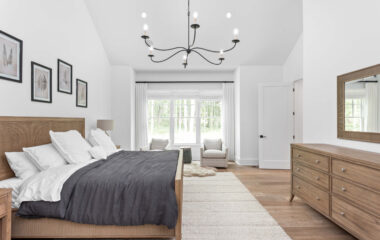 A bedroom with lighting and window shades.