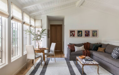 A charming cottage-style home living area with window blinds.
