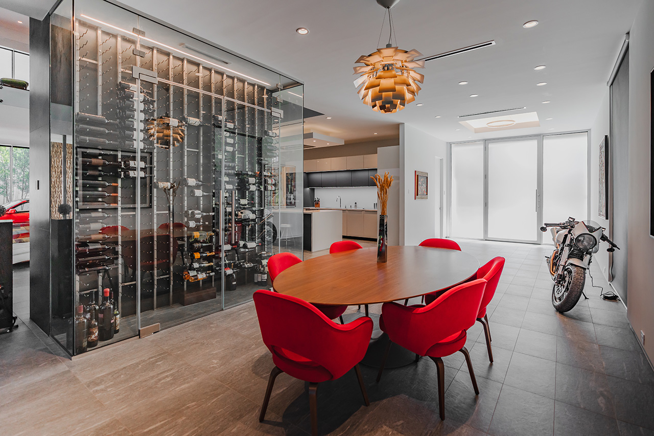 A modern home interior with table and chairs and a spectacular wine rack.