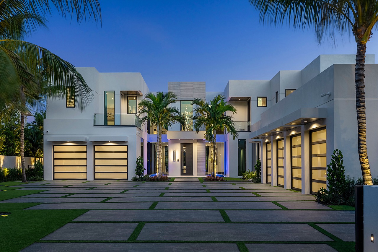 An exterior view of a luxury home in Florida at dusk.