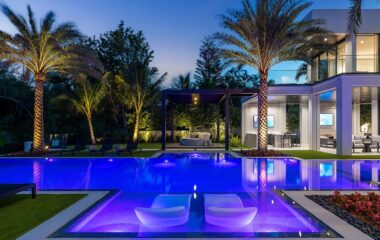 Luxury Boca Estate exterior and pool at dusk.