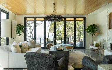 A luxury lakefront retreat living area with open motorized shades.