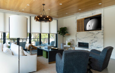A luxury lakefront retreat living area with motorized shades and recessed ceiling lighting.